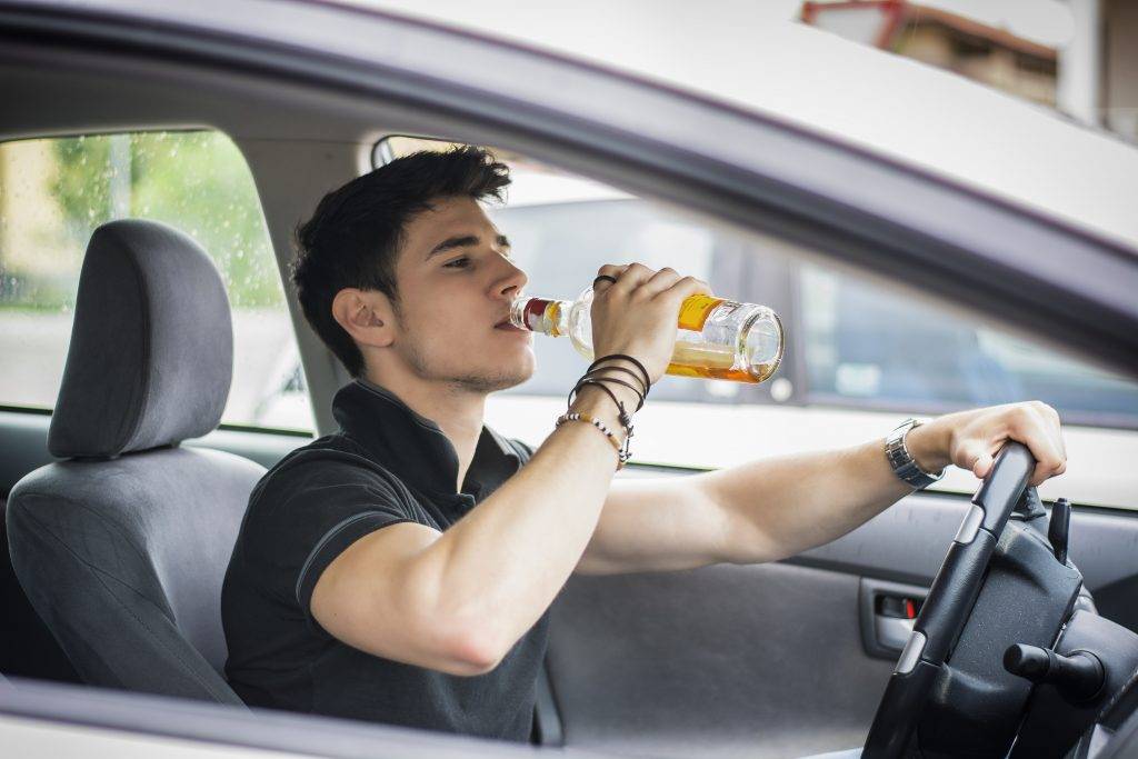 Young-Man-Driving-His-Car-Whil