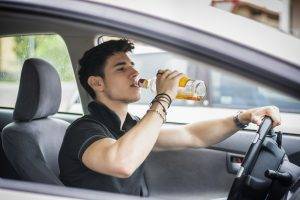 Young-Man-Driving-His-Car-Whil