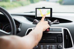 Close-up Of Female's Hand Using GPS Navigation Inside Car